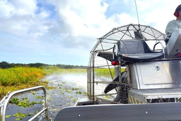 The back of an airboat speeding through the waters of the Florida Everglades at Gator Airboat in Orlando.