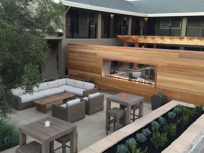 Couches, chairs & fireplace on the patio at The Nest Palo Alto