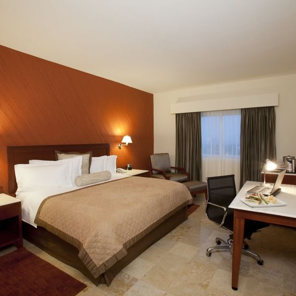 King comfy bed with a TV in Superior Room at Gamma Hotels