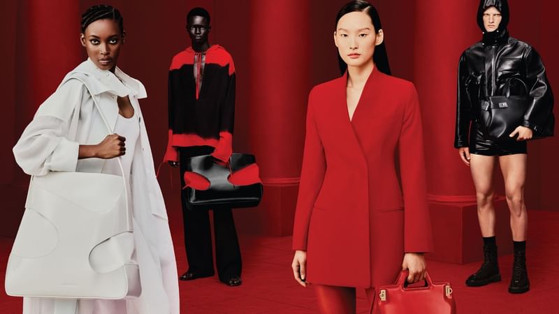 Four models posing in red and white outfits against a red backdrop at Crown Hotels Melbourne