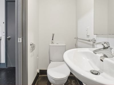 Modern bathroom with toilet and sink at Student Living Auckland - Beach.