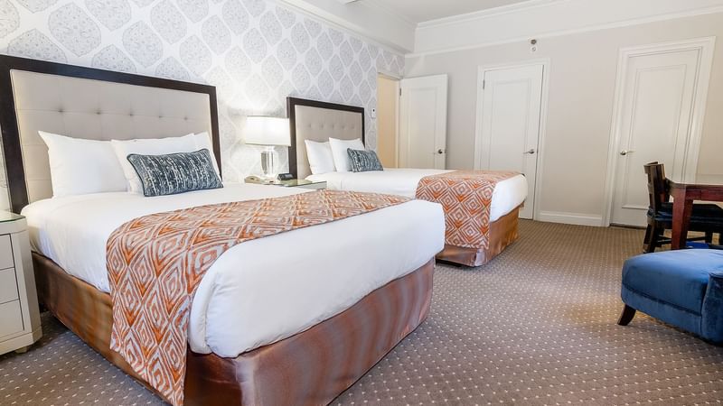Comfy twin bed with side tables and Tv in Premier City View Suite at Warwick New York