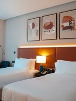 Two comfortable Deluxe Rooms with modern decor and amenities at Warwick Hotel & Spa in Jeddah.