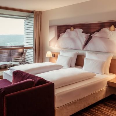 Bed with comfy sheets in Superior room, Falkensteiner Hotels