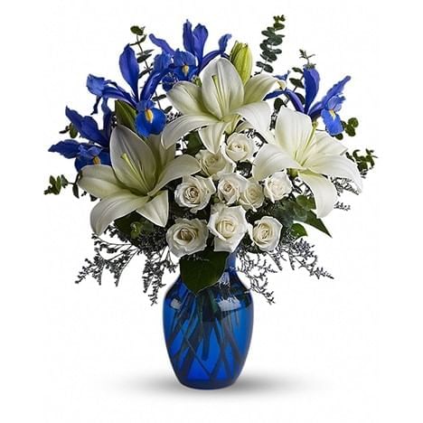 Bouquet of white lilies, roses, and blue flowers in a vase at Hotel X Toronto