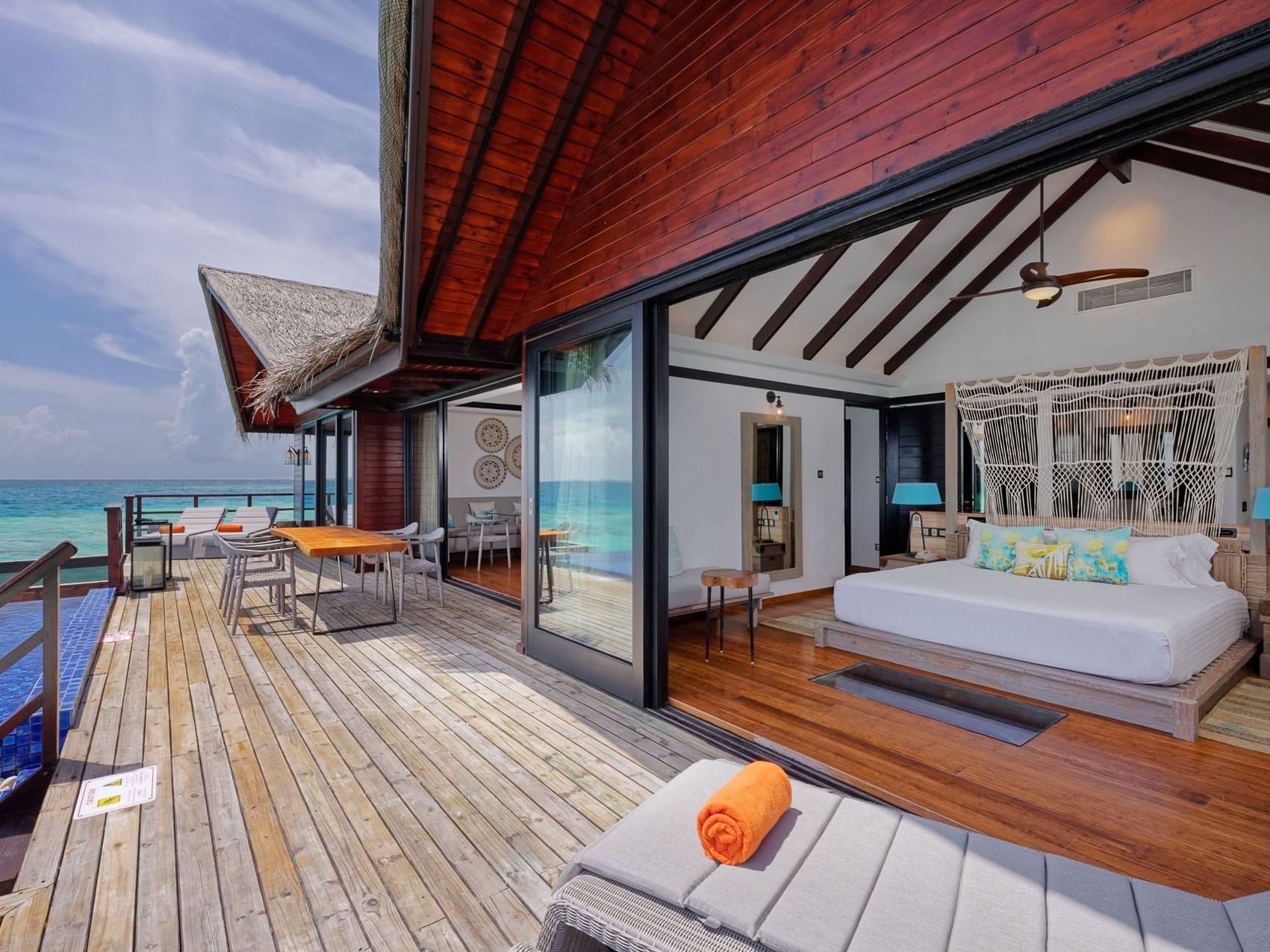 Overwater Grand Residence with open patio, bed and ocean view at Grand Park Kodhipparu, Maldives