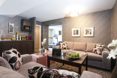 couches next to a kitchen area in a hotel room