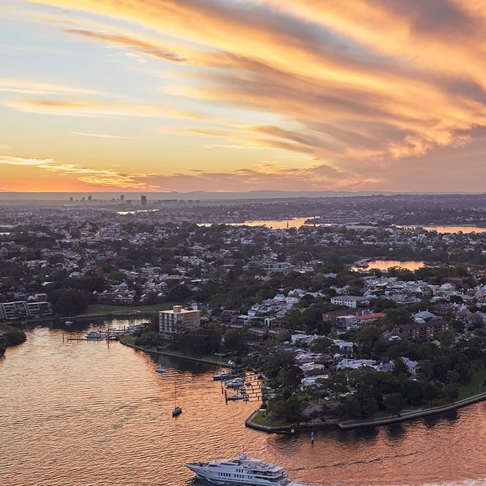 Aerial view of the city and river at sunset near Crown Hotels