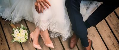 Bride and groom's feet on a floor at Amora Hotel Chiang Mai