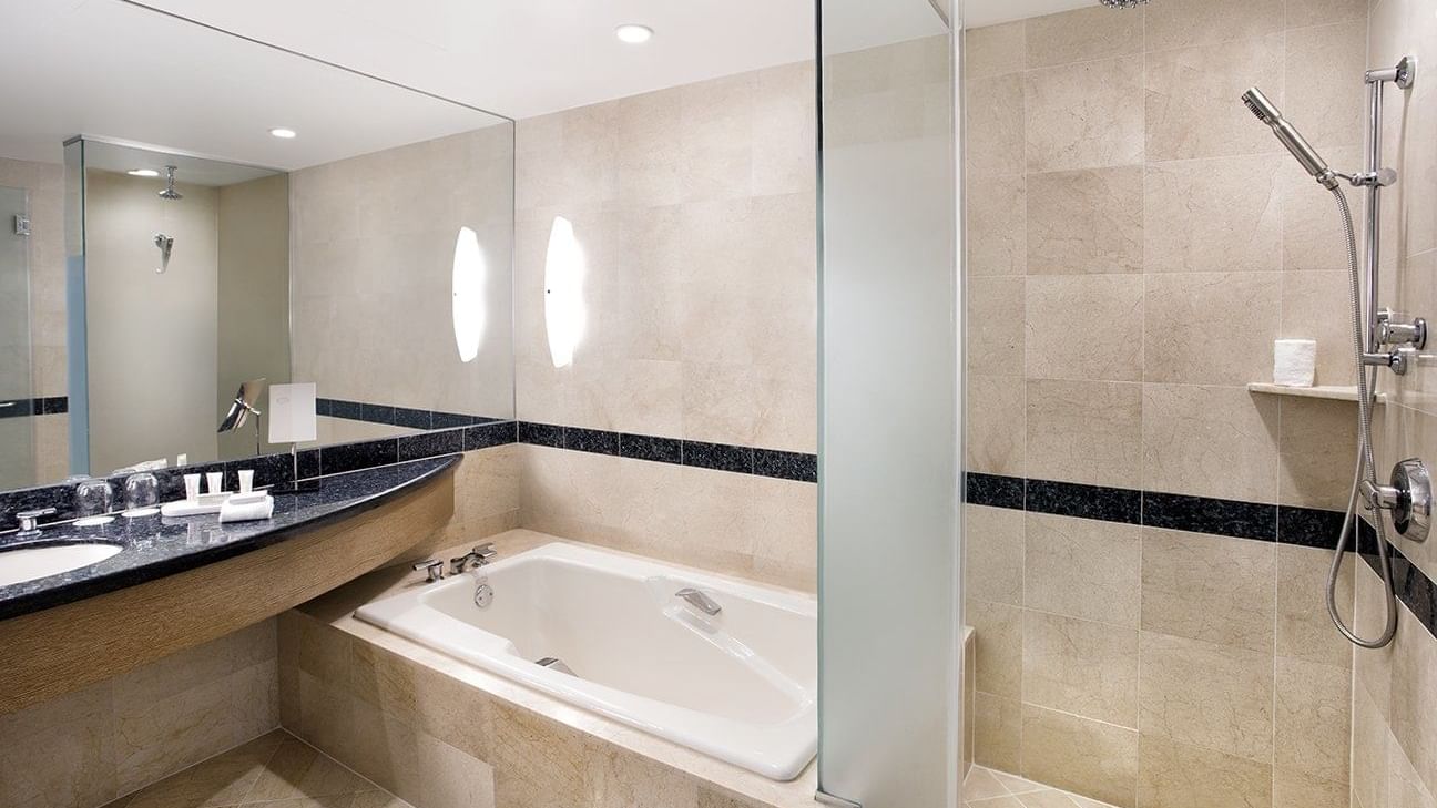 Bathroom vanity & bathtub in Corner Suite bathroom at The Diplomat Resort