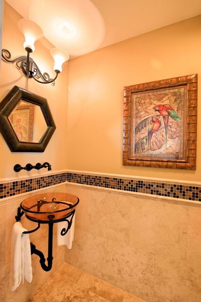 A sink mirror and a wallpaint at Windsong Resort On The Reef
