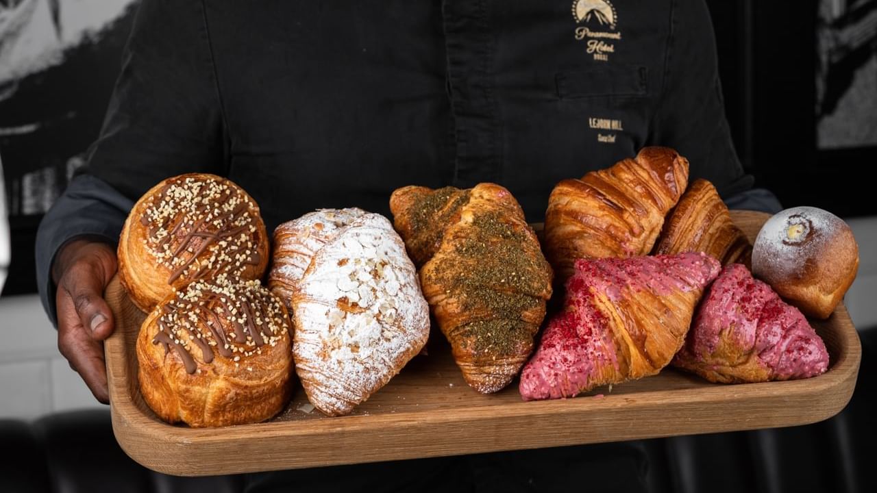 Chef holding a tray of croissants in Craft Table Artisan Café & Bakery at Paramount Hotel Dubai