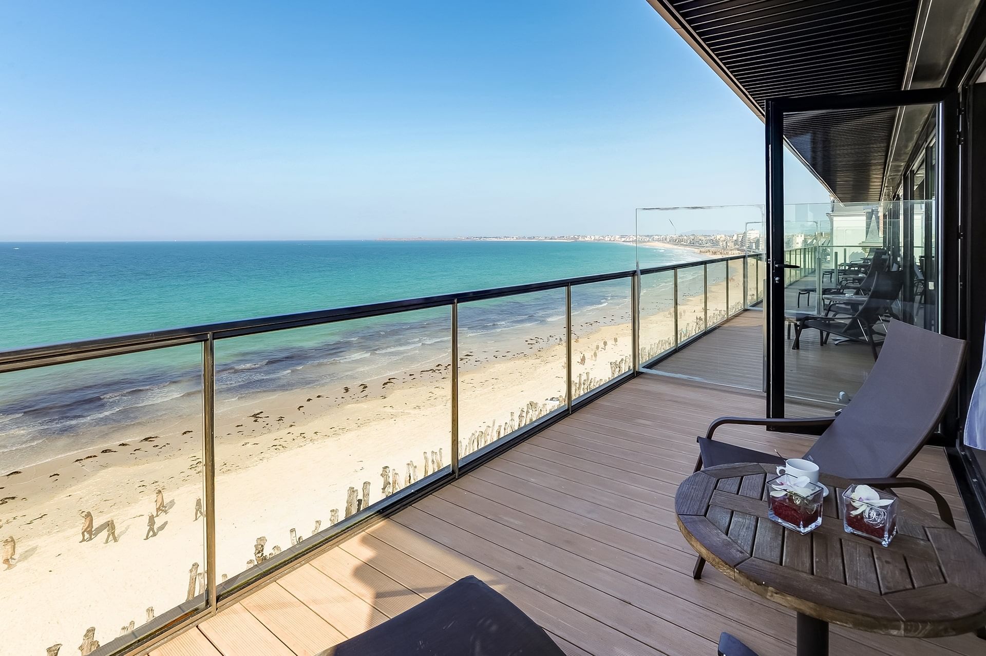 Ocean view a long balcony with loungers at Oceania Hotels