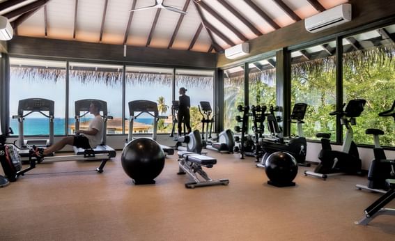 Gym with exercise equipment, overlooking the ocean at Grand Park Kodhipparu, Maldives