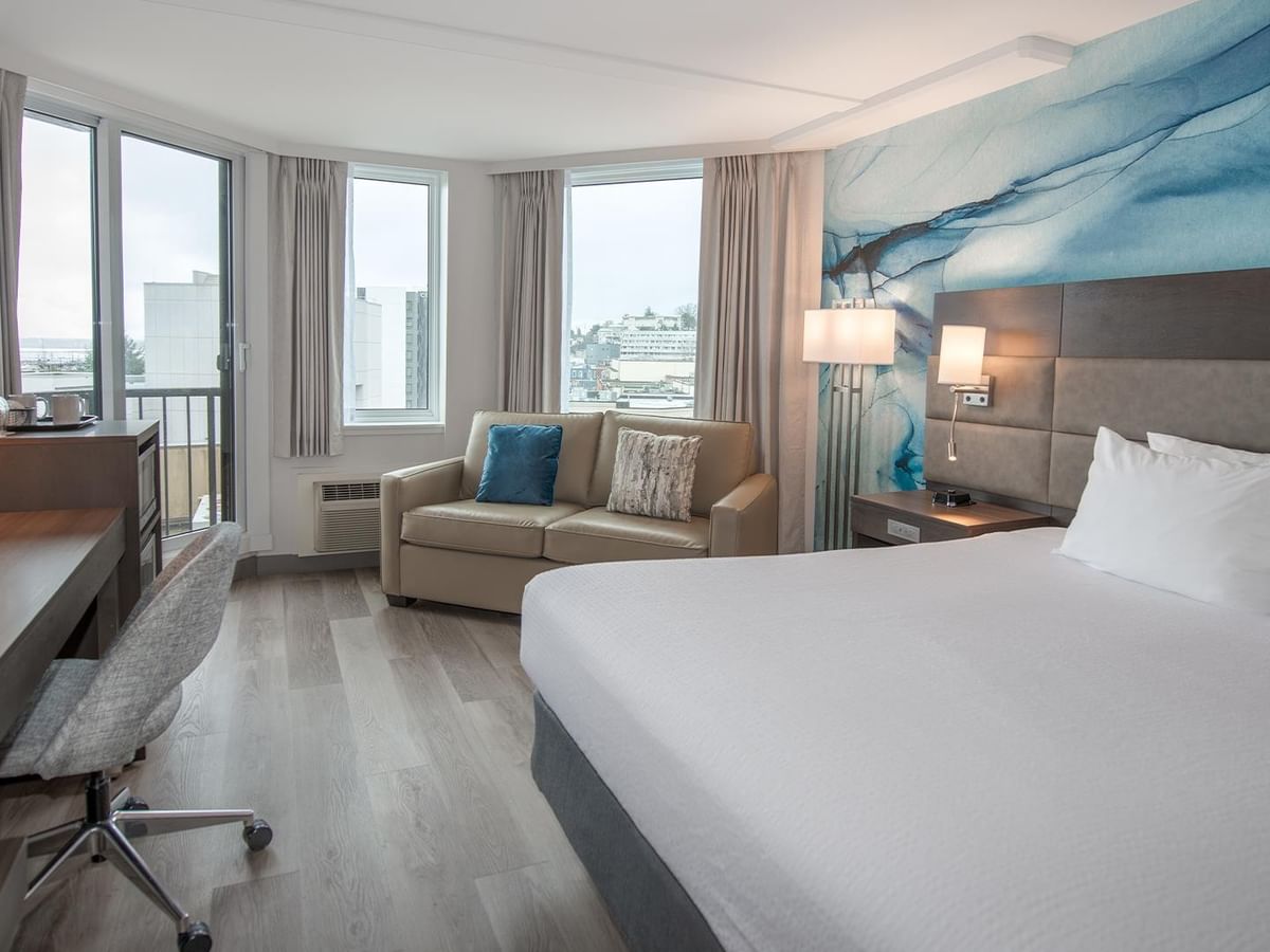 King size bed, couch, and desk in Coast Accessible King room at Coast Bastion Hotel in Nanaimo.