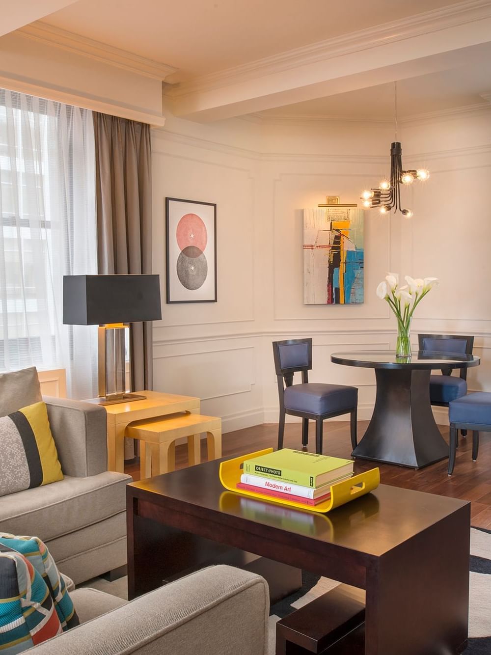 Modern Art Suite living area with plush seating and a dining table at Warwick New York