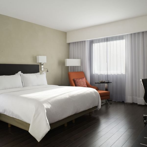 King bed in Superior Room with working desk at Fiesta Inn