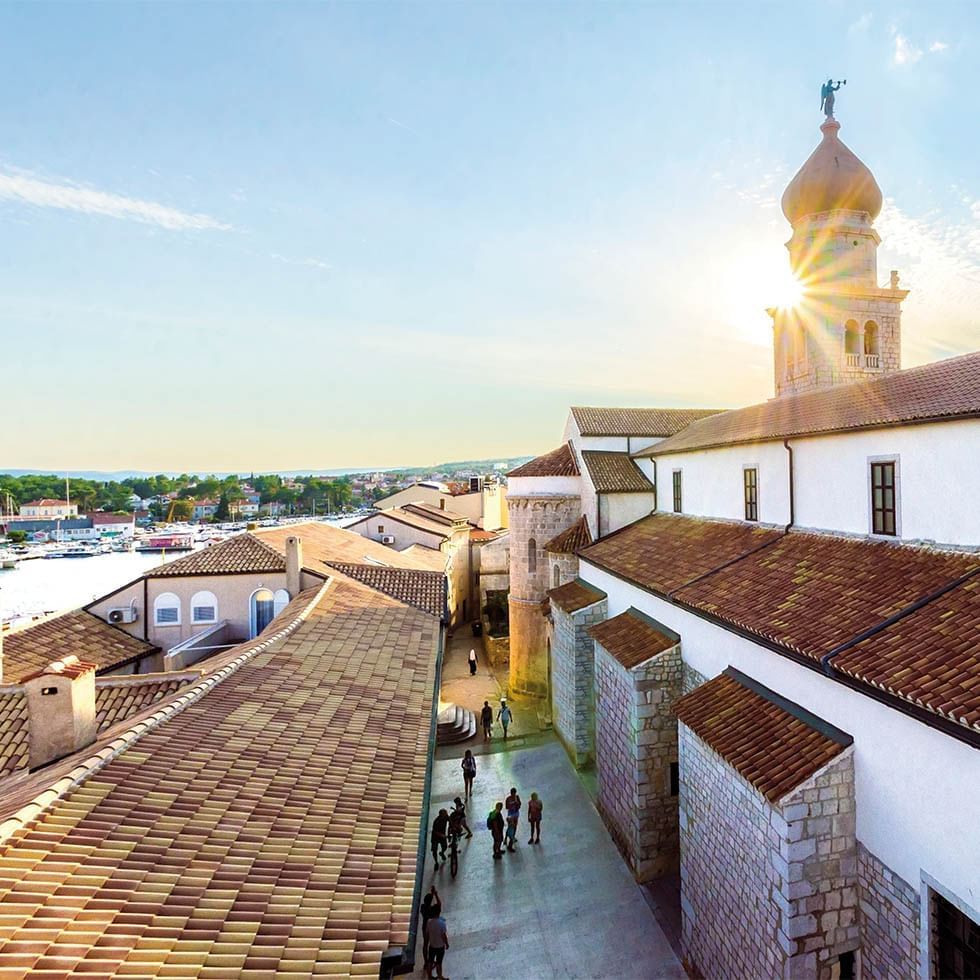 Sun rays hit the roofs of buildings, Krk, Falkensteiner Hotels