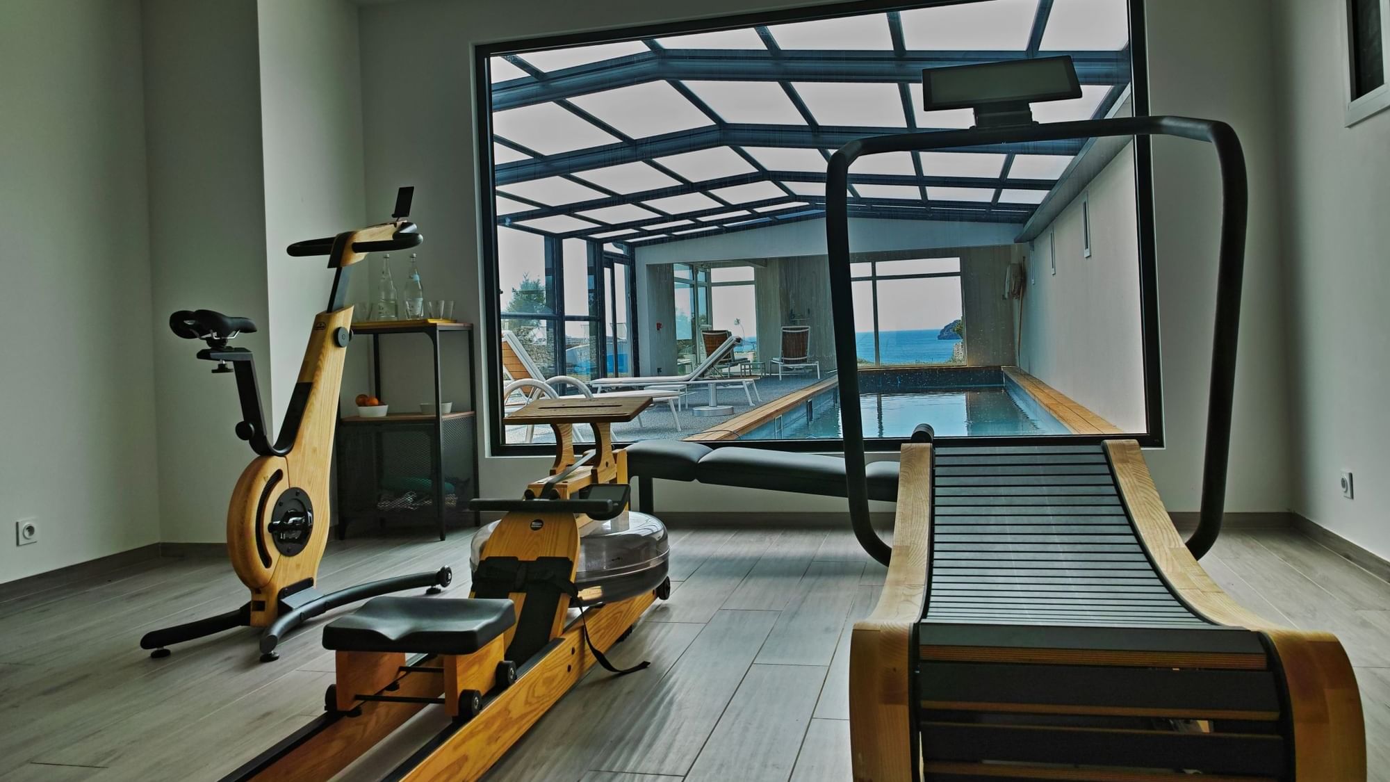 Interior of a gym facing the pool area at Originals Hotels