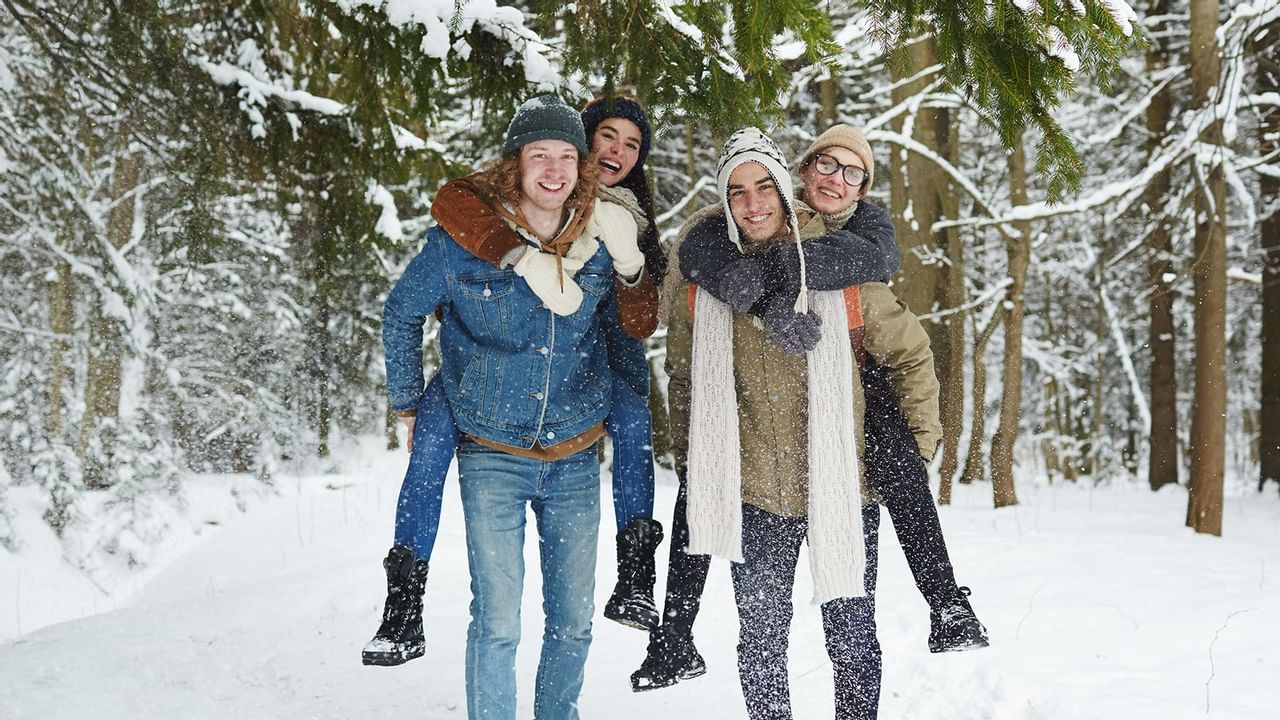 Friends walking in the snow near  The Oceanside Hotel
