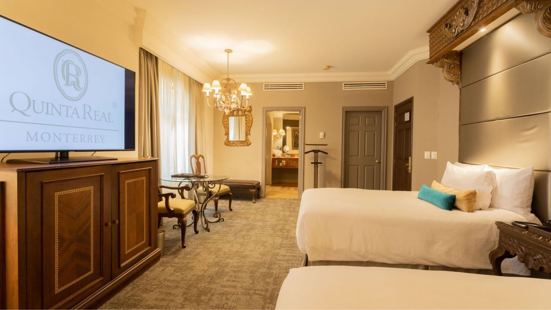 2 Double Master Suite view showing a television, sitting area, and an open door to the bedroom at Quinta Real Monterrey