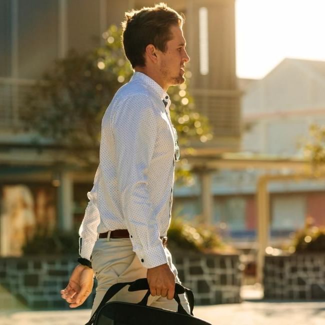 Man walking to work as a way to increase his NEAT exercise