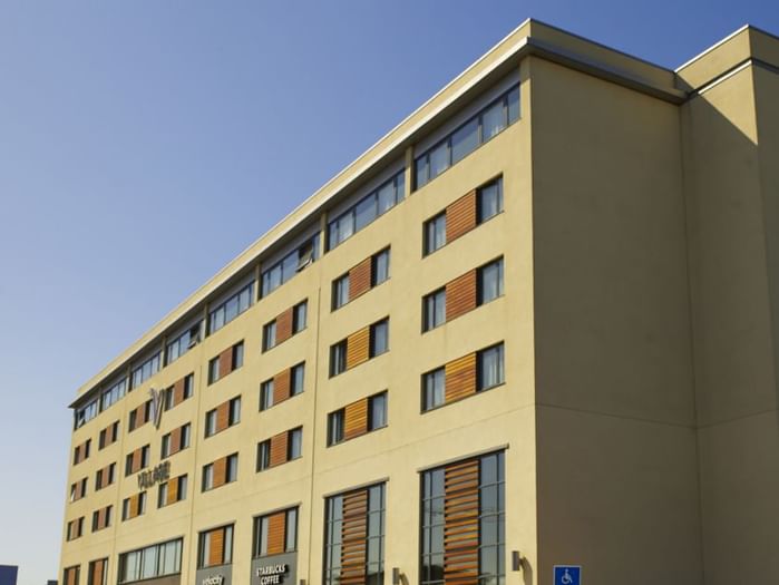 An exterior view of the hotel & car park at Village Hotels