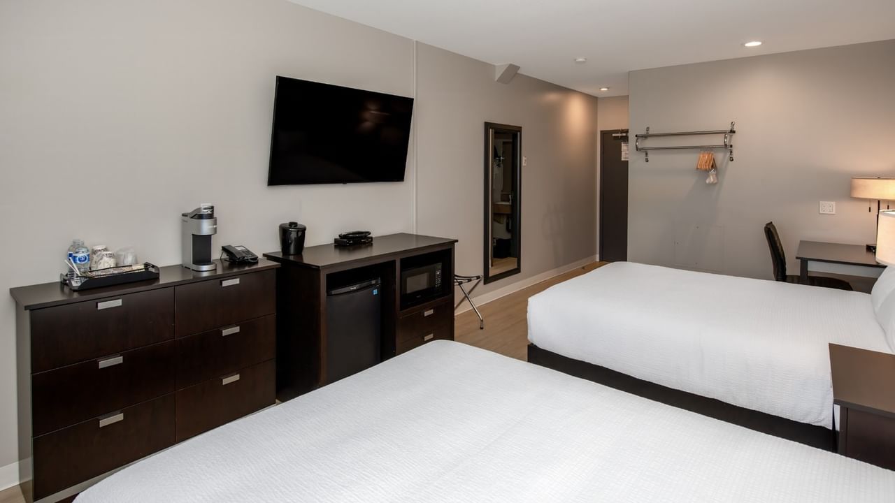 Guest room at Coast Innisfail Hotel with beds, TV and in-room amenities