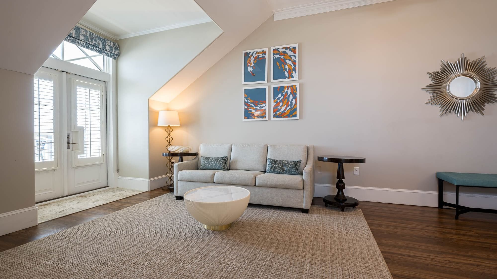 King Suite living area with couch, coffee table, and modern art at The Pearl Hotel in Rosemary Beach.