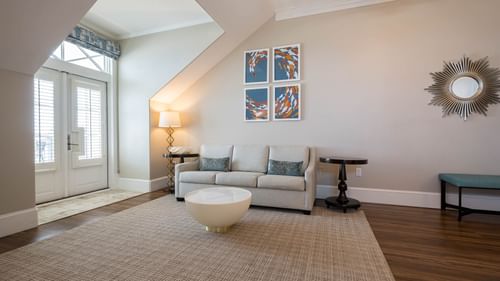 King Suite living area with couch, coffee table, and modern art at The Pearl Hotel in Rosemary Beach.