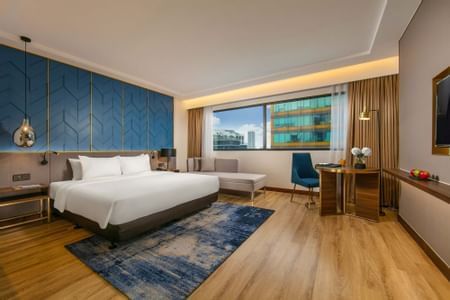 King size bed in a room with Cityscape views at Eastin Hotel