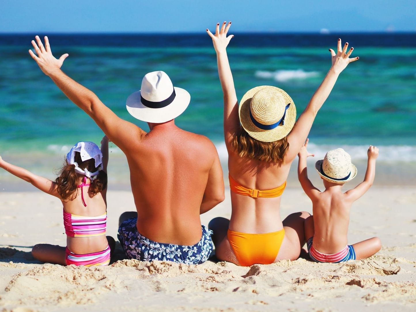 Family playing on beach at Daydream Island Resort