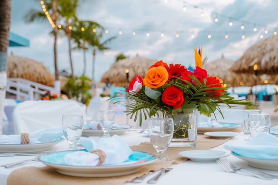 Beachside table arrangement with white linens & glassware at Amsterdam Manor Beach Resort Aruba