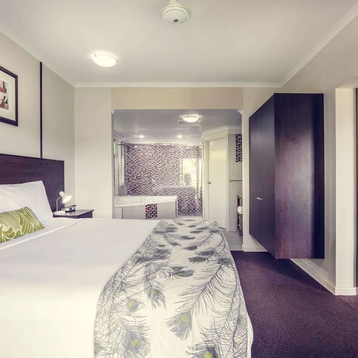 Interior of a room with a king bed at Darwin Airport Hotels