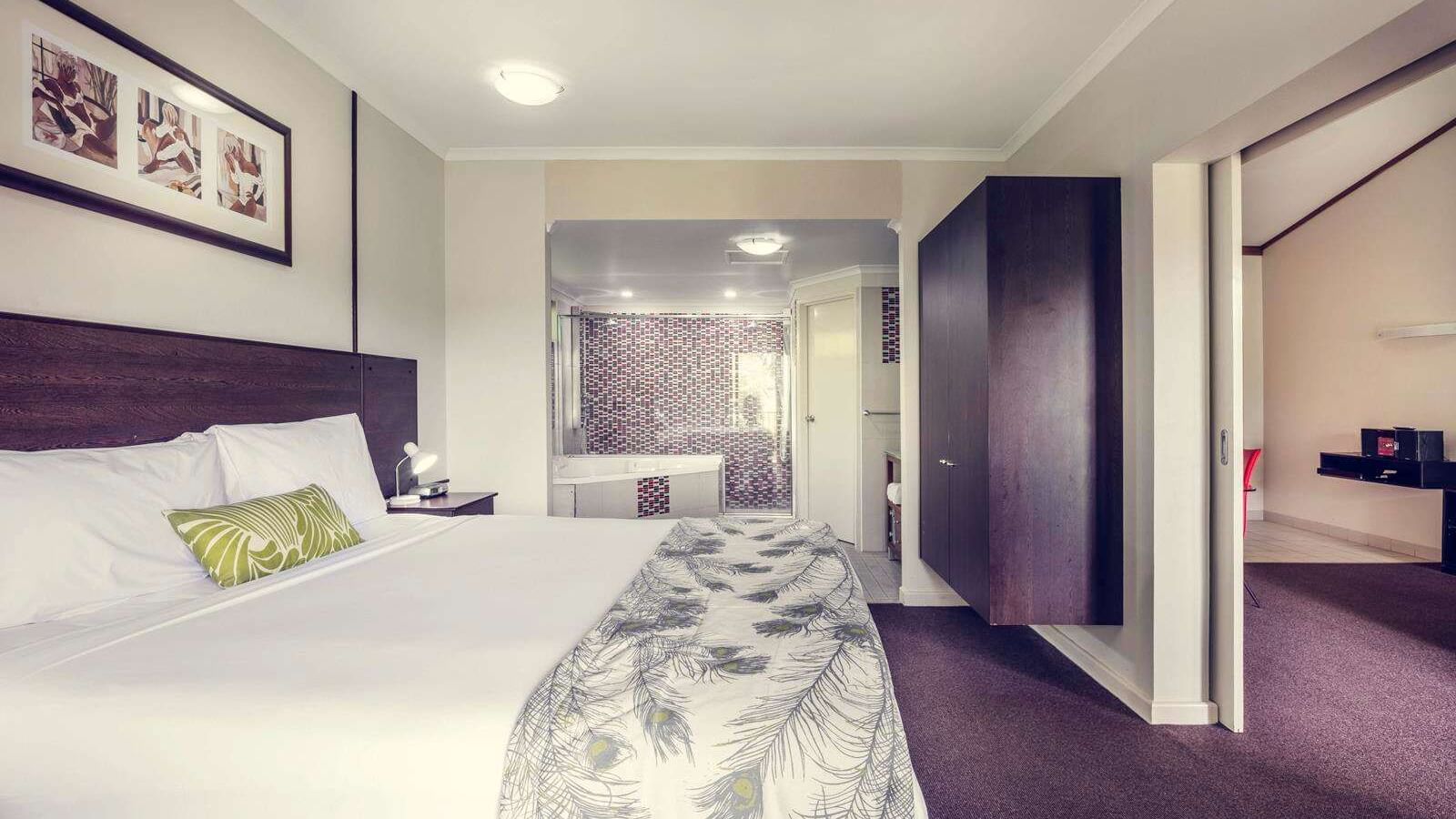 Interior of a room with a king bed at Darwin Airport Hotels