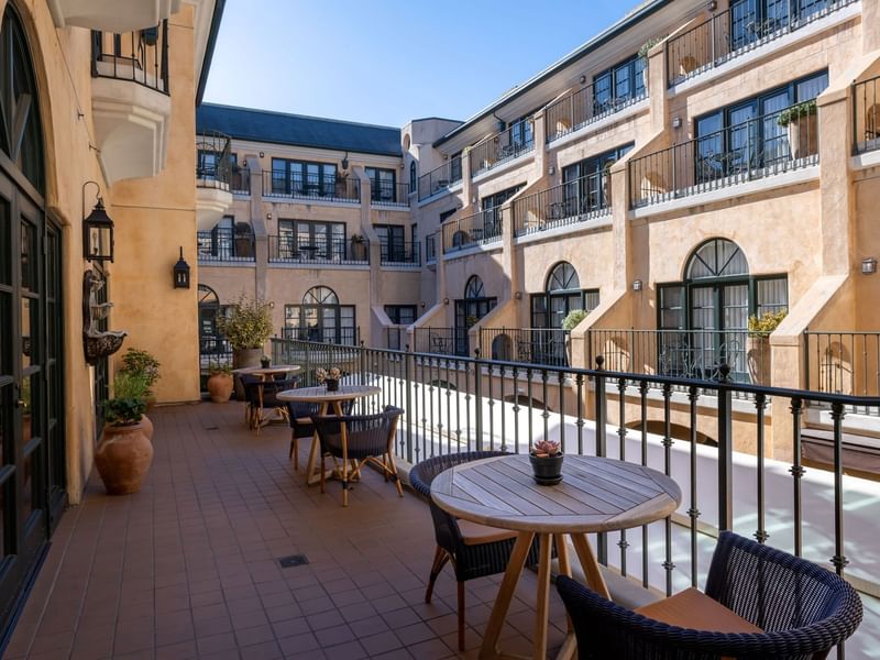Il Fornaio Restaurant Patio with tables and chairs, offering views of the charming architecture at El Prado Hotel