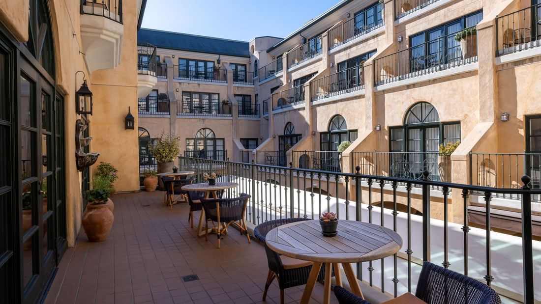 Il Fornaio Restaurant Patio with tables and chairs, offering views of the charming architecture at El Prado Hotel