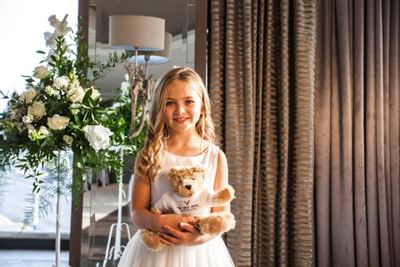A girl holding a teddy bear at a wedding at The View Eastbourne