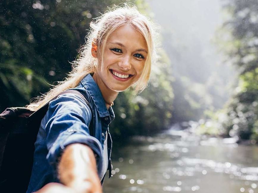A Lady smiling by a water stream near Retreat Costa Rica