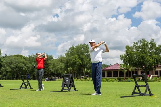 Two men playing golf at the Golf Club in Mystic Dunes Resort