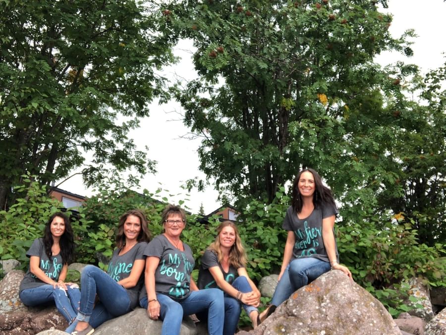 family posing for photo on rocks