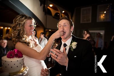Married couple feeding each other their wedding cake