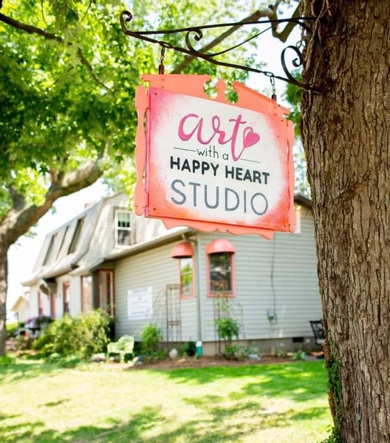 Art with a Happy Art Studio sign board near The Whittaker Inn