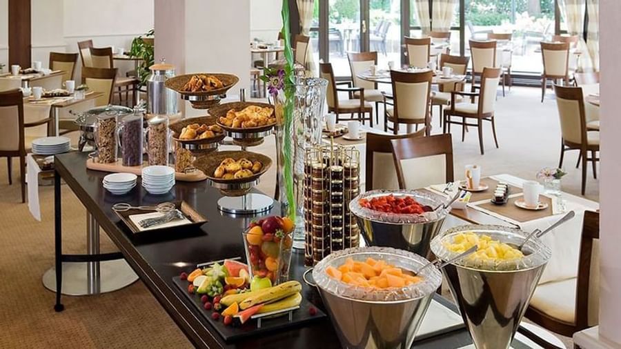 Elegant breakfast buffet in a bright, spacious dining area in the Roseraie Room at Warwick Reine Astrid - Lyon