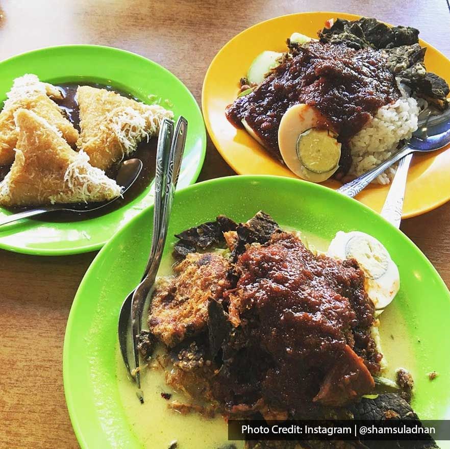 Nasi lemak dish served on a street food stall table near Imperial Lexis Kuala Lumpur, Jalan Alor best food