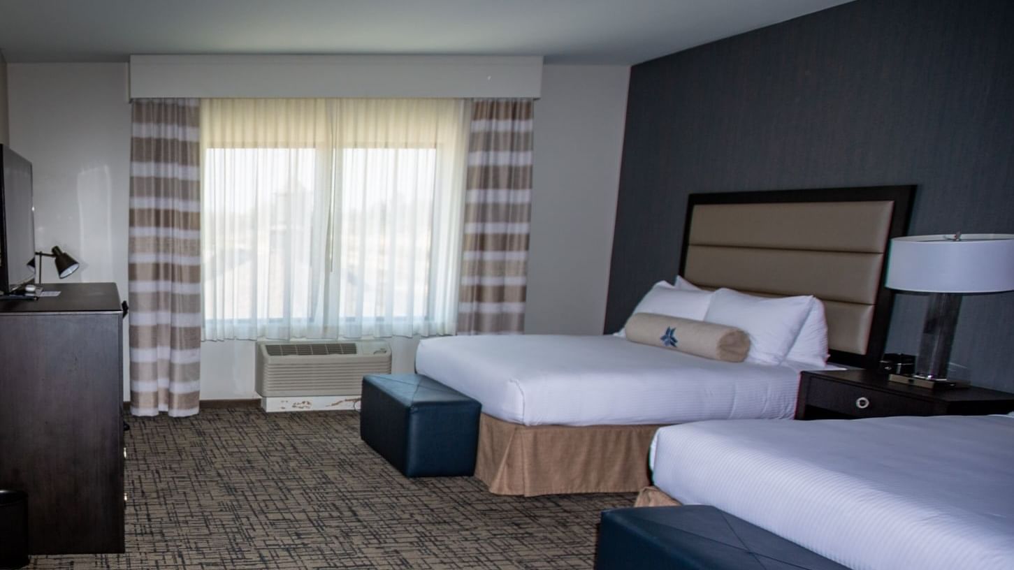 Double queen guestroom featuring two queen-sized beds and a spacious sitting area at Shangri-La Monkey Island