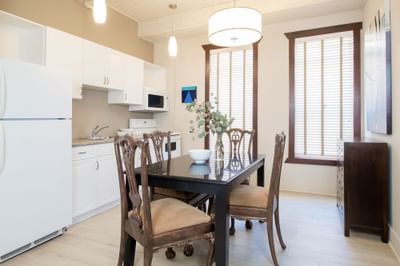 Kitchen space with dining table in Apartment 406 at Retro Suites Hotel