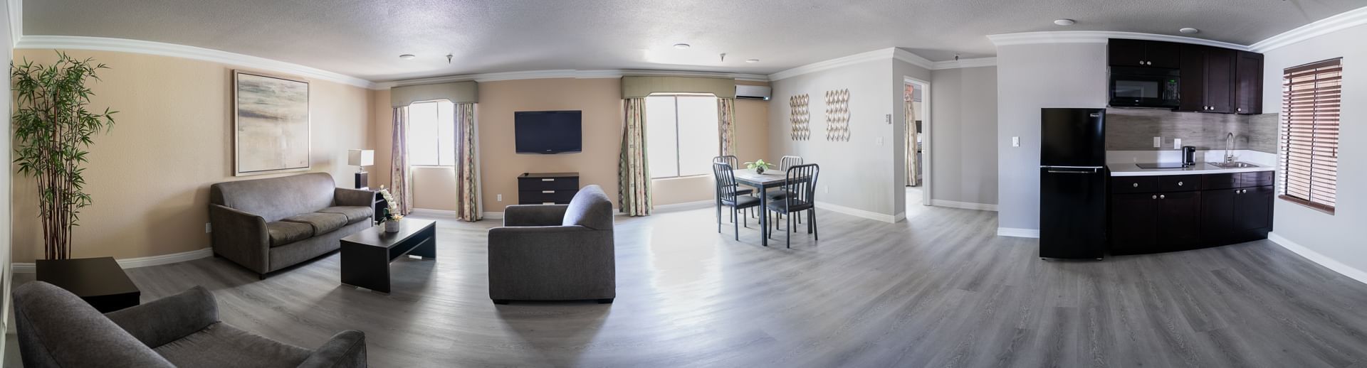 A wide view of a suite's living and kitchen area