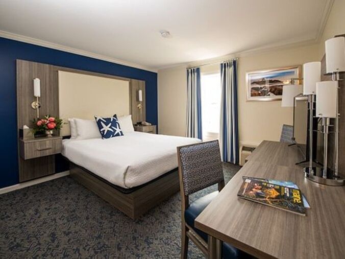 Workspace & TV facing the bed in Queen Center Oceanfront Room at Union Bluff Hotel