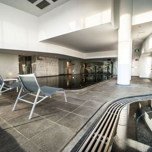 Indoor Pool area with loungers at Pullman Quay Grand Sydney